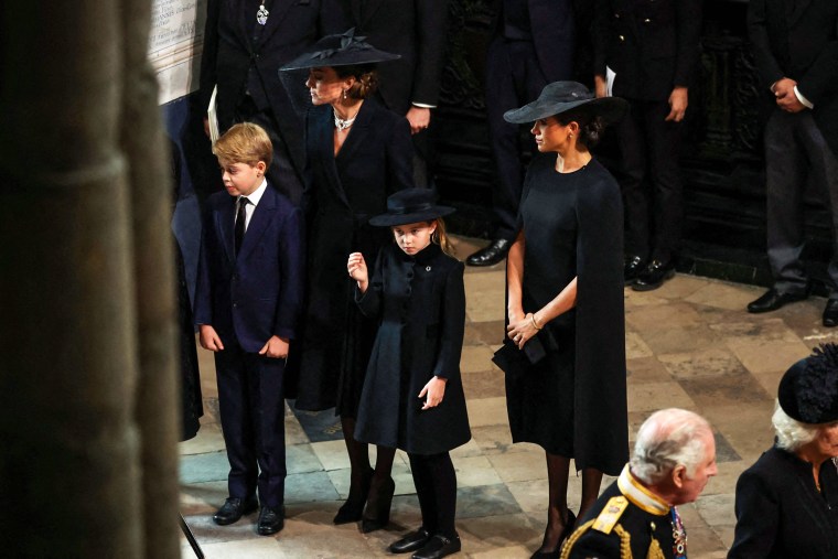 Image: Catherine, Princess of Wales, Meghan, Duchess of Sussex, Prince George, Princess Charlotte, Britain's King Charles III and Britain's Camilla, Queen Consort attend the state funeral and burial of Britain's Queen Elizabeth, at Westminster Abbey in London on  Sept. 19, 2022.