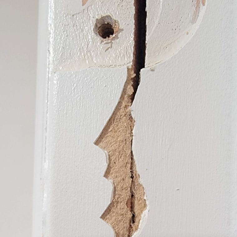 A section of a cracked door. 