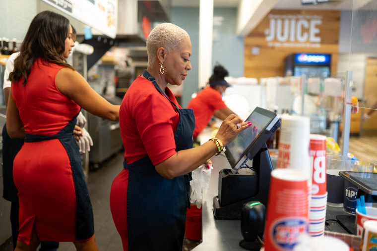 Co-owner Charmaine Ward-Millner works behind the counter at Jersey Mike's in Atlanta.