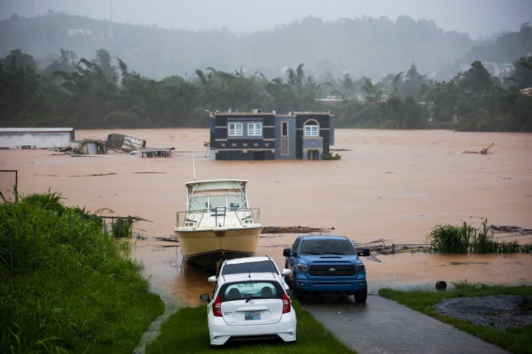 People inside a house await rescue from the floods caused by Hurricane Fiona in Cayey, Puerto Rico, on Sept. 18, 2022.