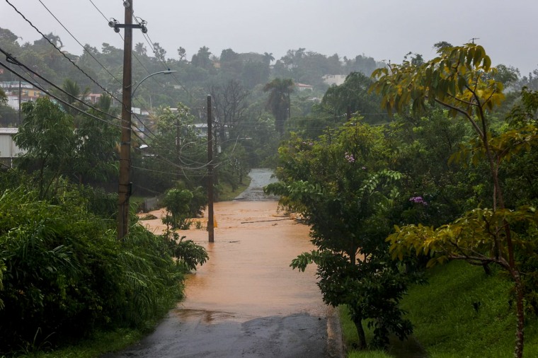 A road is flooded by the rains of Hurricane Fiona in Cayey, Puerto Rico, on Sept. 18, 2022.