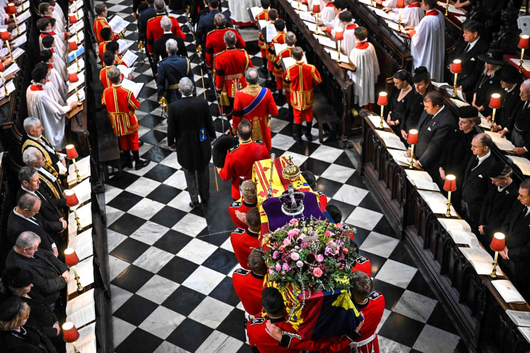 Image: The coffin of Queen Elizabeth II, draped in the Royal Standard, is carried inside Westminster Abbey in London on Sept. 19, 2022, ahead of the State Funeral Service.