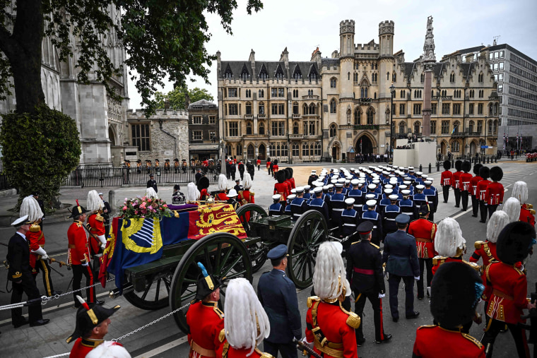 Image: The coffin of Queen Elizabeth II, draped in the Royal Standard, arrives at Westminster Abbey in London on Sept. 19, 2022, for the State Funeral Service for Britain's Queen Elizabeth II.