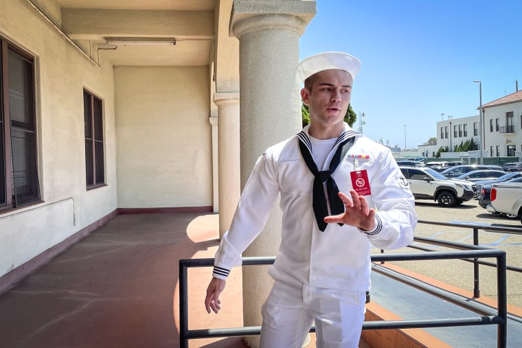 Image: U.S. Navy sailor Ryan Sawyer Mays walks past reporters at Naval Base San Diego before entering a Navy courtroom on Aug. 17, 2022, in San Diego.