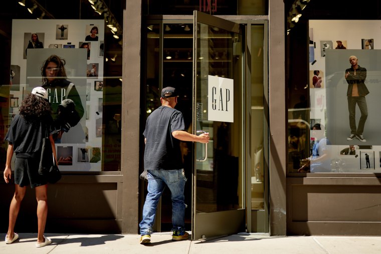 A customer enters a Gap retail store
