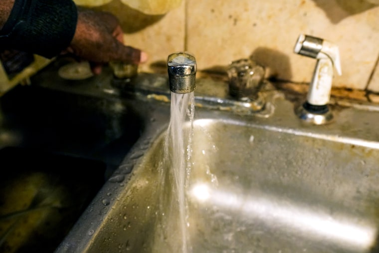 Water flows from the faucet in a home in Jackson, Miss., on Sept . 7, 2022.