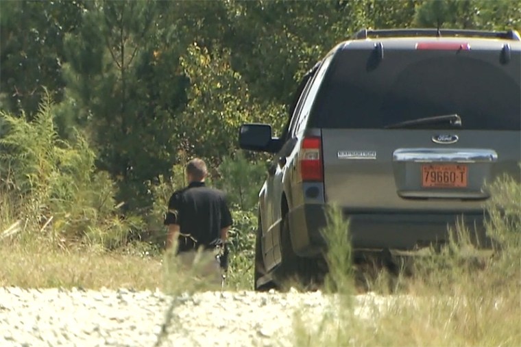 Police investigate the area in Orange County, North Carolina, where the bodies of two teenagers were found after they were reported missing over the weekend.