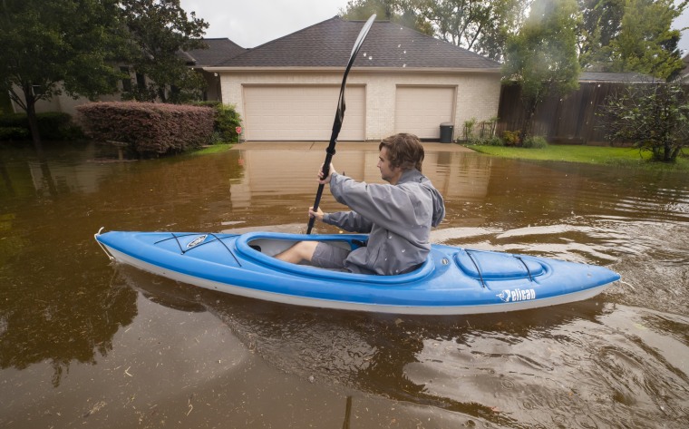 Kyle Harner kayaks along a flooded street in Friendswood, Texas, on Sept. 22, 2020. 