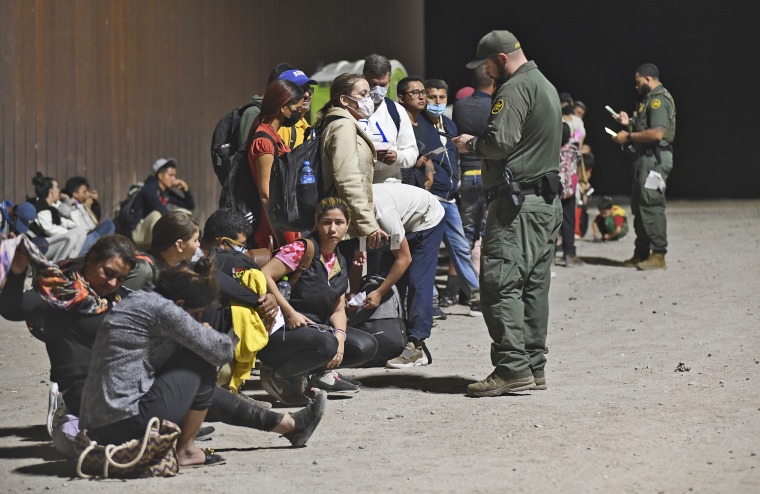 Migrants are detained by U.S. Customs and Border Protection