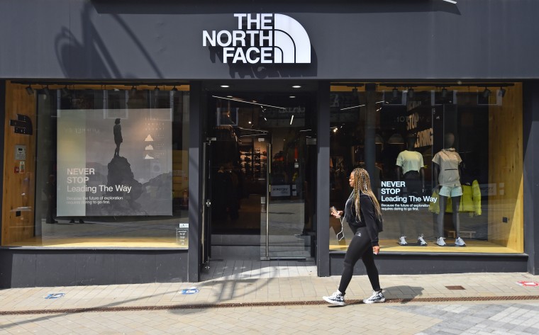 A women walks past a North Face store in Leeds, England, on May 27, 2021.