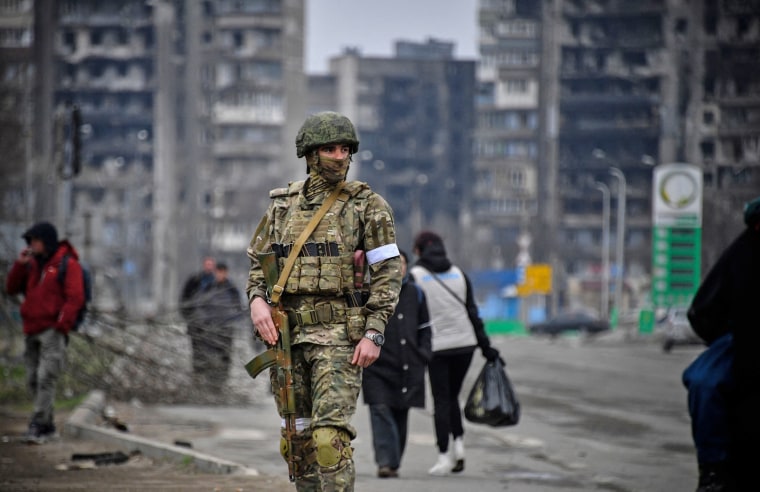 A Russian soldier patrols in Mariupol, Ukraine