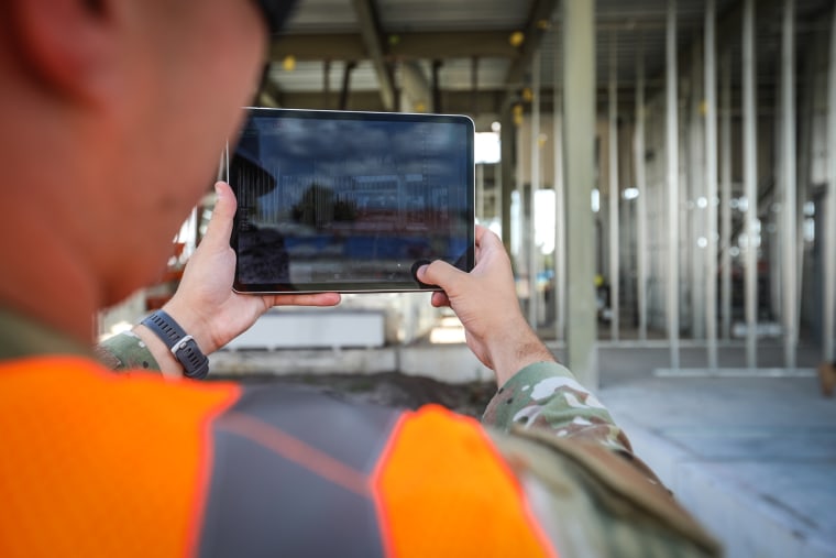 Nicholas Cap, Natural Disaster Recovery Division, USAF, demonstrates digital twin thinking augmented reality in the new headquarters building.