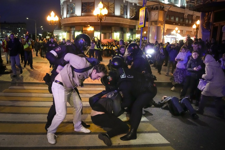 Russian riot police detain demonstrators during a protest