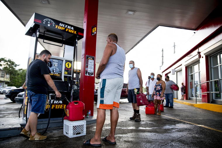 People wait in line at the Top Fuel gas station to fill their tanks on Sept. 20, 2022, in Cabo Rojo, Puerto Rico.