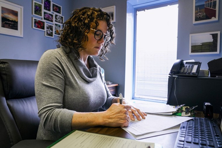 Dr. Katie McHugh, an obstetrician-gynecologist, looks over abortion content forms as she works at the Women's Med Center in Indianapolis, on Sept. 23, 2022.
