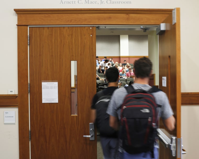 Students enter a classroom at the University of Georgia