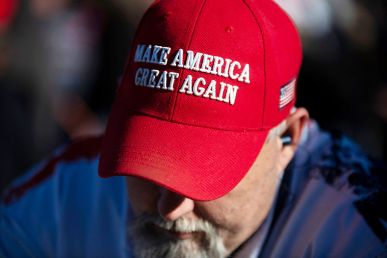 A person wears a MAGA hat