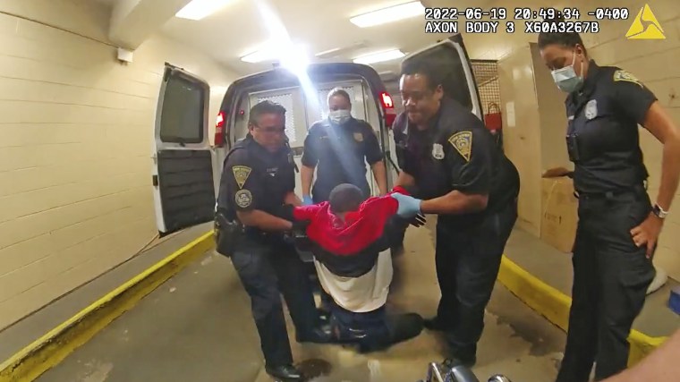 Randy Cox is pulled from the back of a police van and placed in a wheelchair after having been detained by New Haven police on June 19. 