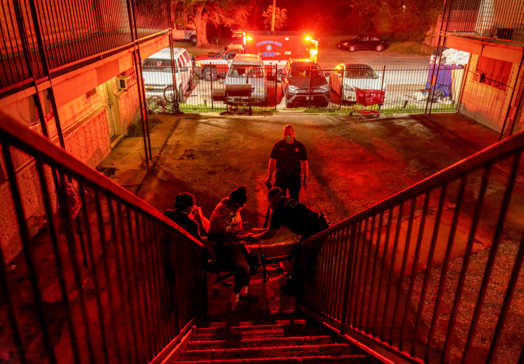 Image: Houston Fire Department EMS medics transport a Covid-positive patient to a hospital in Texas on Aug. 20, 2021. The Delta variant was overwhelming area hospitals.