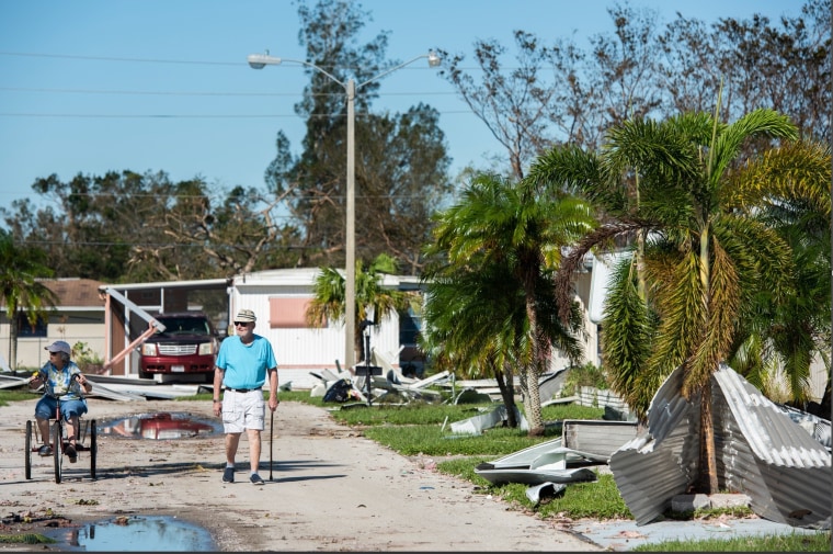 Residents survey the damage in Poinsettia Park in Fort Myers, Fla., on Sept. 30, 2022.