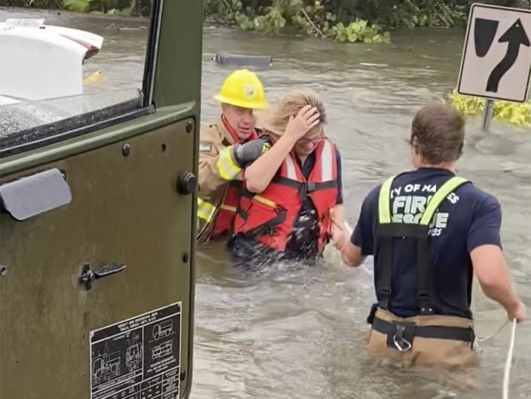Crews help rescue a stranded motorist from flooding caused by Hurricane Ian on Sept. 28, 2022 in Naples, Fla.