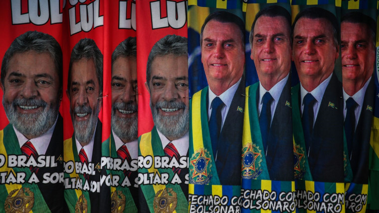 En un puesto de mercado cuelgan toallas de cuerpo con las imágenes de Luiz Inácio Lula da Silva sobre un fondo rojo, como el color de su Partido de los Trabajadores, y de Jair Bolsonaro sobre un fondo azul de la bandera brasileña.
