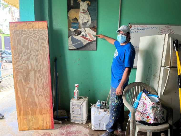 Angel Vega, who does maintenance for the sanctuary and who has worked at the shelter for 7 years, points out how high the flood waters reached inside the first floor.