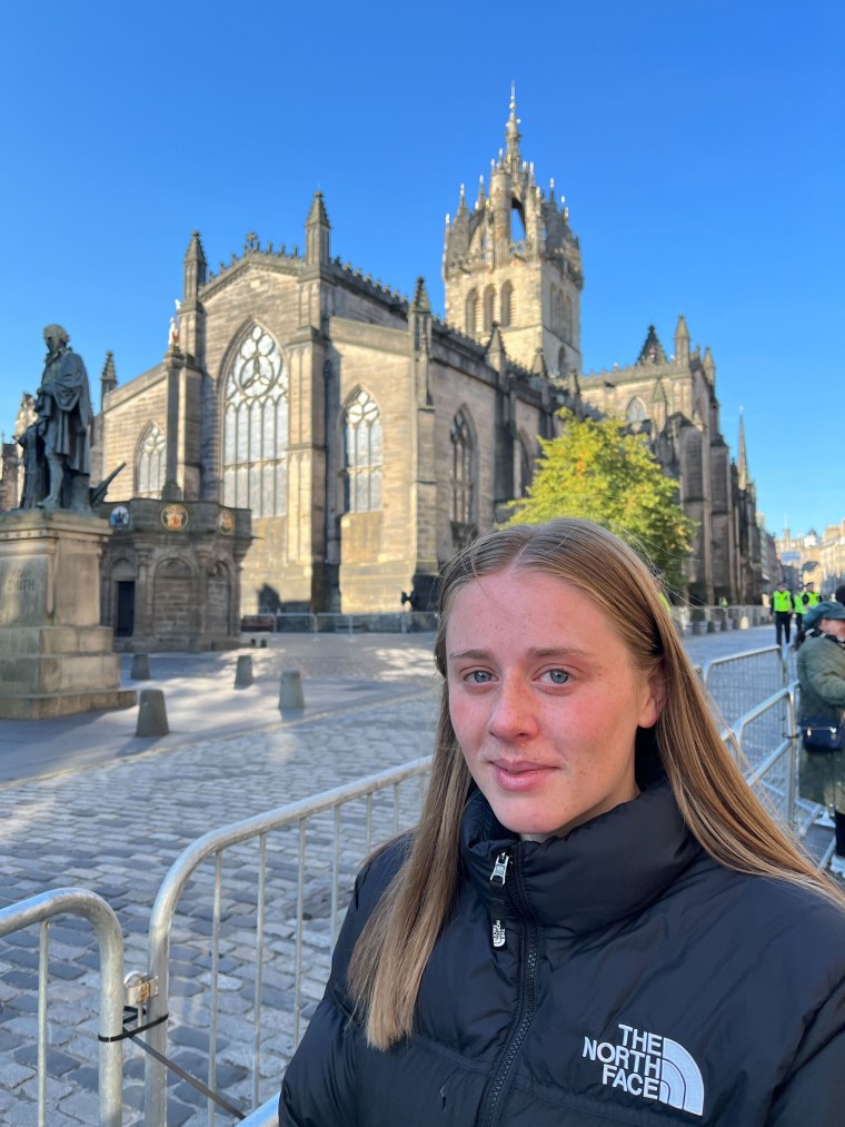 Charlotte Morrison, 20, walks out of St. Giles Cathedral in Edinburgh, Scotland, in tears after paying her respects to Queen Elizabeth II on Tuesday morning.