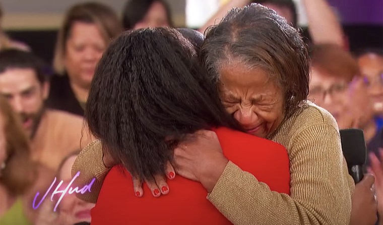 Jennifer Hudson hugs an emotional audience member after an impromptu gospel performance