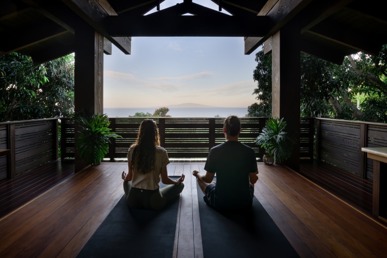 couple doing yoga at Hotel Wailea in Maui, Hawaii