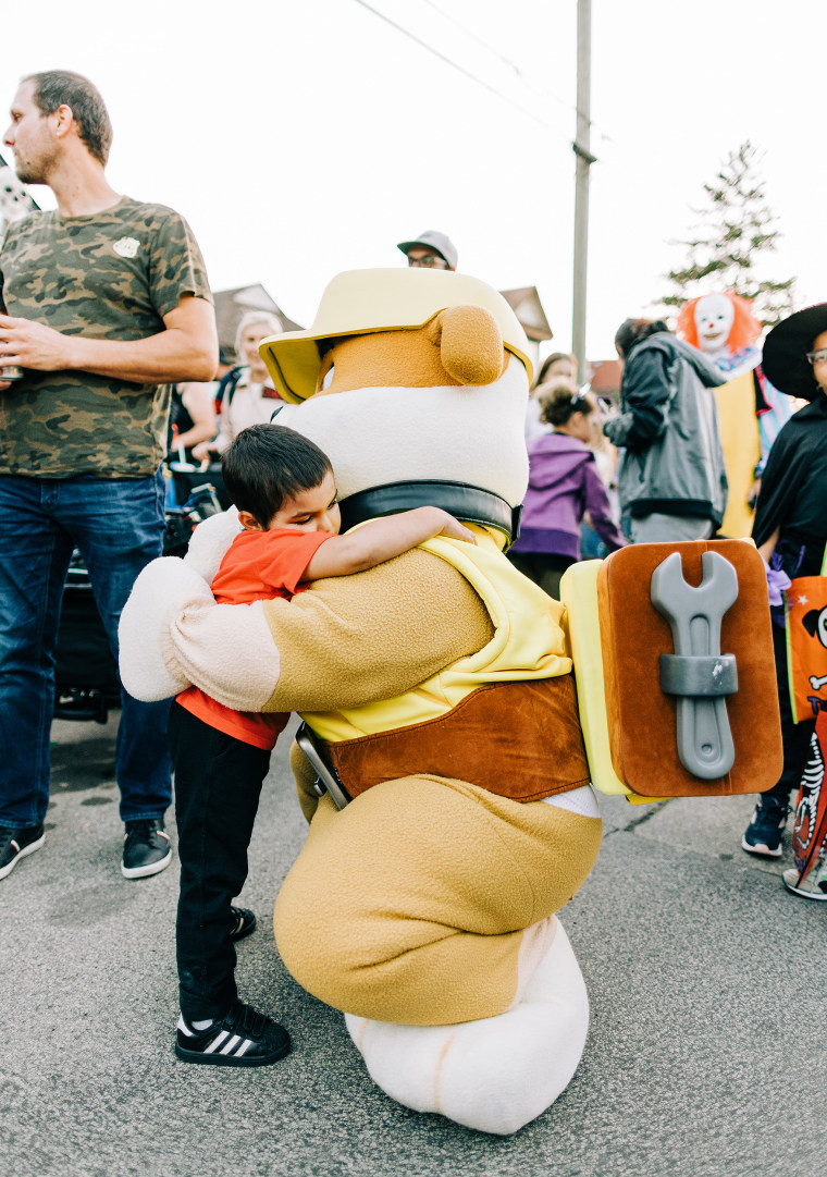 Alexandros Hurdakis gets one of many hugs at the special Halloween bash thrown in his honor.