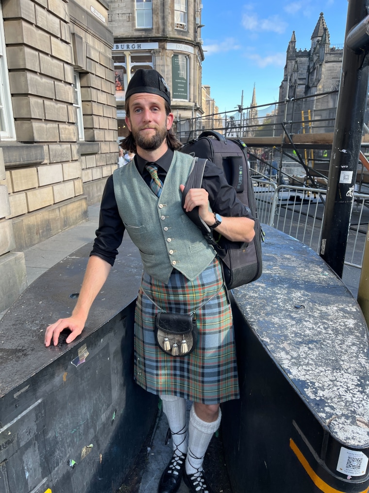 Bagpiper Cailean Gillies stands on Edinburgh's Royal Mile outside St. Giles' Cathedral.