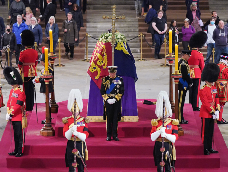 King Charles III in front of Queen Elizabeth II's coffin