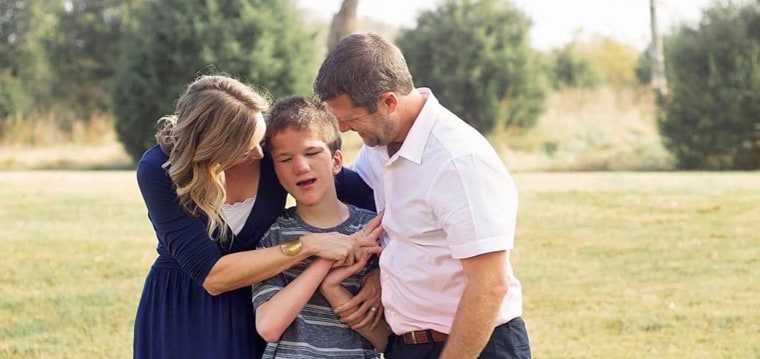 Jessica and Ryan Ronne hug their son, Lucas.