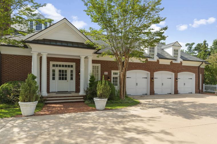 The home features a three-car garage with ample parking outdoors for guests.