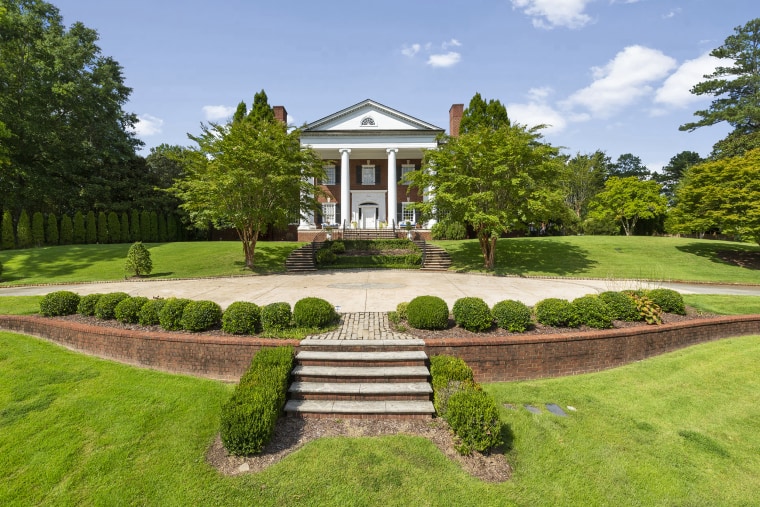 The home is situated on a private hilltop with classic Southern architecture.