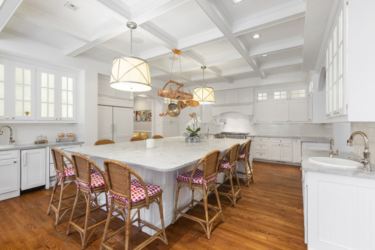 Several rooms, including the custom kitchen, feature coffered ceilings for an added luxurious detail.