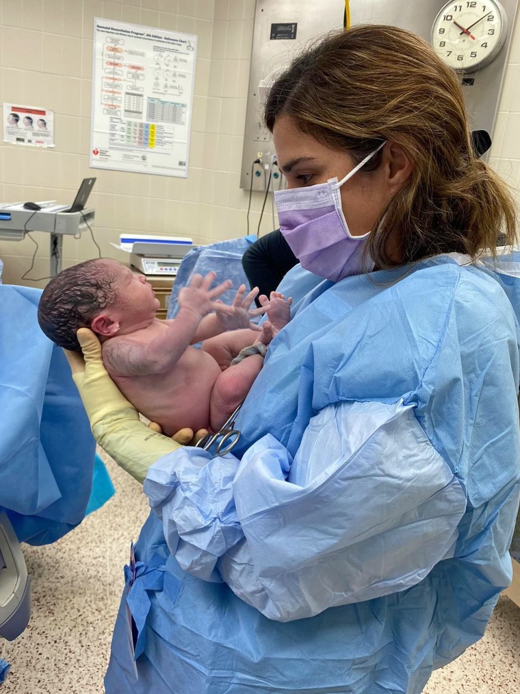 Dr. Zaskia Rodriguez, meeting a patient's newborn for the first time.