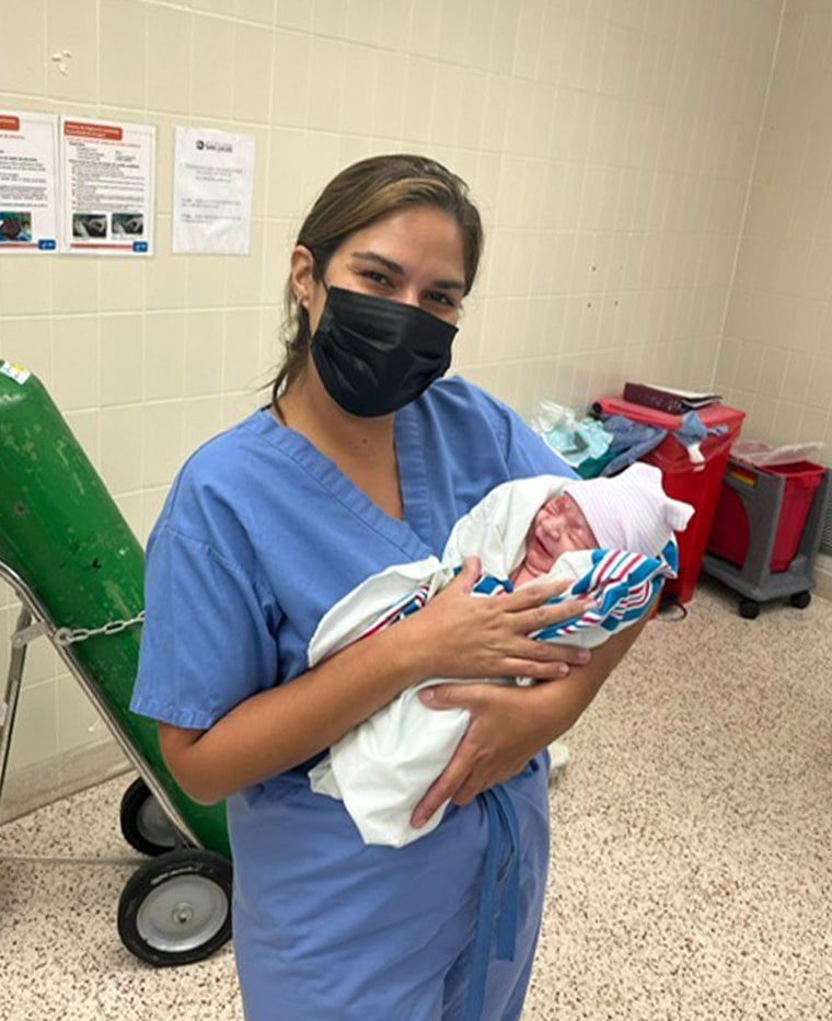 Dr. Zaskia Rodriguez, proudly holding a patient's newborn weeks before Hurricane Fiona hit Puerto Rico. 