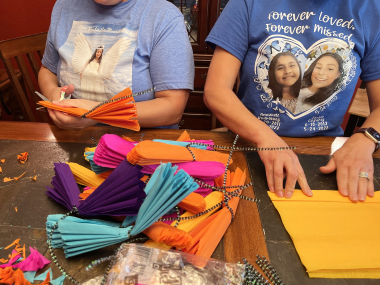 Jackie's aunts, Julissa and Jaunita, wear their memorial T-shirts as they make flowers for Día De Los Muertos.