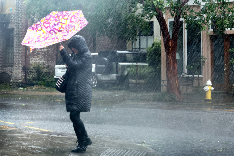 A pedestrian carries an umbrella during heavy rain from Hurricane Ian, in Charleston, SC, on Friday.  on September 30, 2022