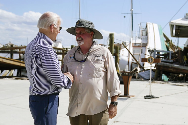 President Joe Biden shakes hands with Fort Myers Beach Mayor Ray Murphy as he tours the area impacted by Hurricane Ian, in Fort Myers Beach, Fla., on Wednesday, Oct. 5, 2022.