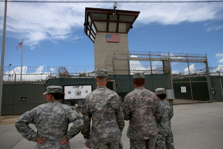 Military officers stand at the entrance at the Guantanamo Bay Facility
