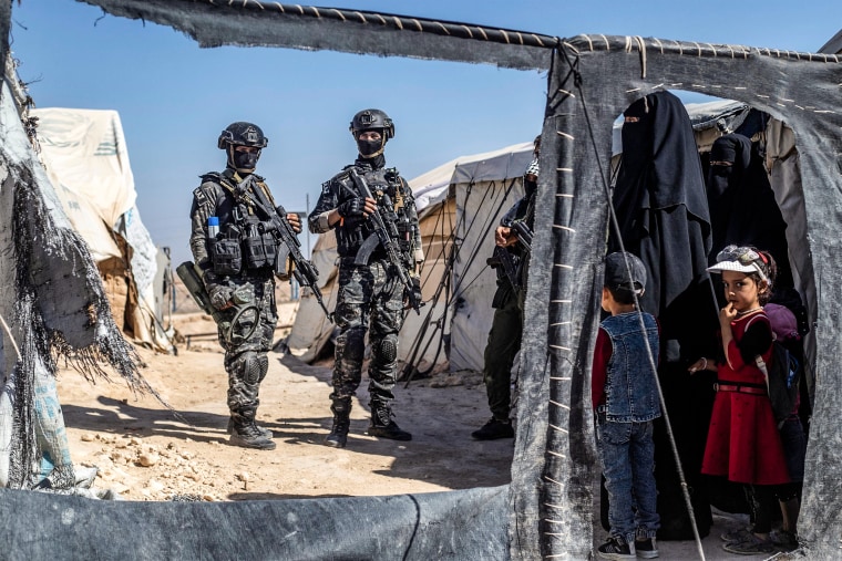 Members of the Syrian Kurdish Asayish security forces inspect tents at the Kurdish-run al-Hol camp, on Aug. 28, 2022, during a security campaign by the Syrian Democratic Forces against IS "sleeper cells" in the camp.