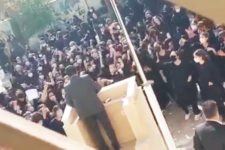 Students at a school in Shiraz chanting “Basiji, go and get lost!” towards a man standing at the podium.