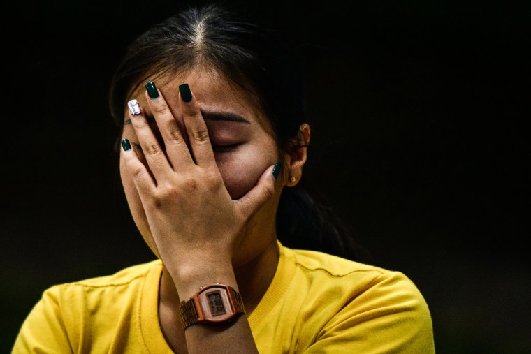 A woman mourns outside a child care center where a former police officer killed at least 38 people on Oct. 6, 2022, in Uthai Sawan subdistrict, Nong Bua Lamphu, Thailand.
