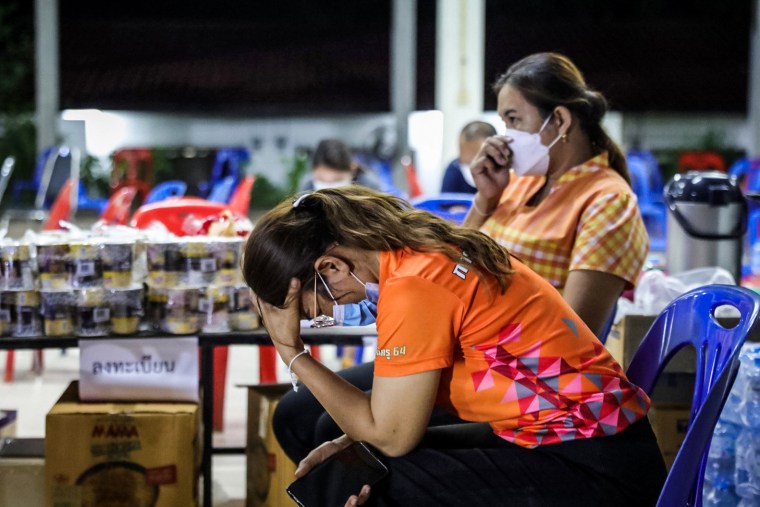 People react outside a child care center where a former police officer killed at least 38 people on Oct. 6, 2022, in Uthai Sawan subdistrict, Nong Bua Lamphu, Thailand.