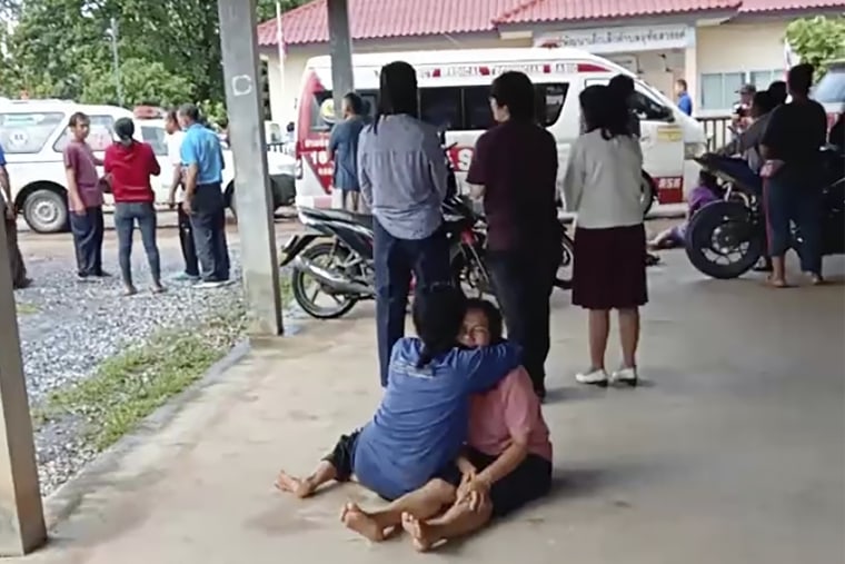 A woman is comforted outside the daycare center after it was attacked on Thursday.