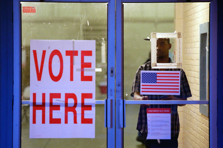 A voter exits a polling station during the presidential primary in Camden, Alabama