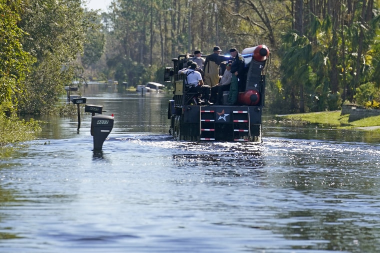 responders drive through flooded neighborhood in North Port, after Hurricane Ian